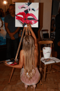 Anfissa Vassé creating live painting with gold leaf at Vision event in Rome